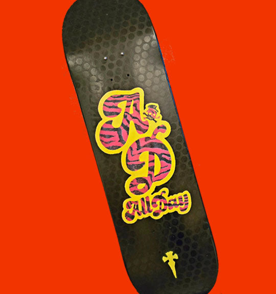Black skateboard deck with pink and yellow All Day design on a red background