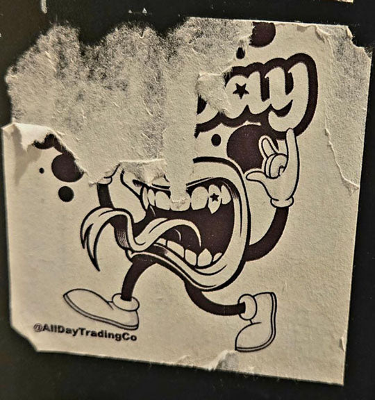 The T.O.T.T. Logo as a sticker which is torn over time